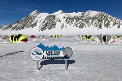 
ALE Union Glacier Antarctica Sign And Very Comfortable Clam Tents With Mount Rossmann Beyond
